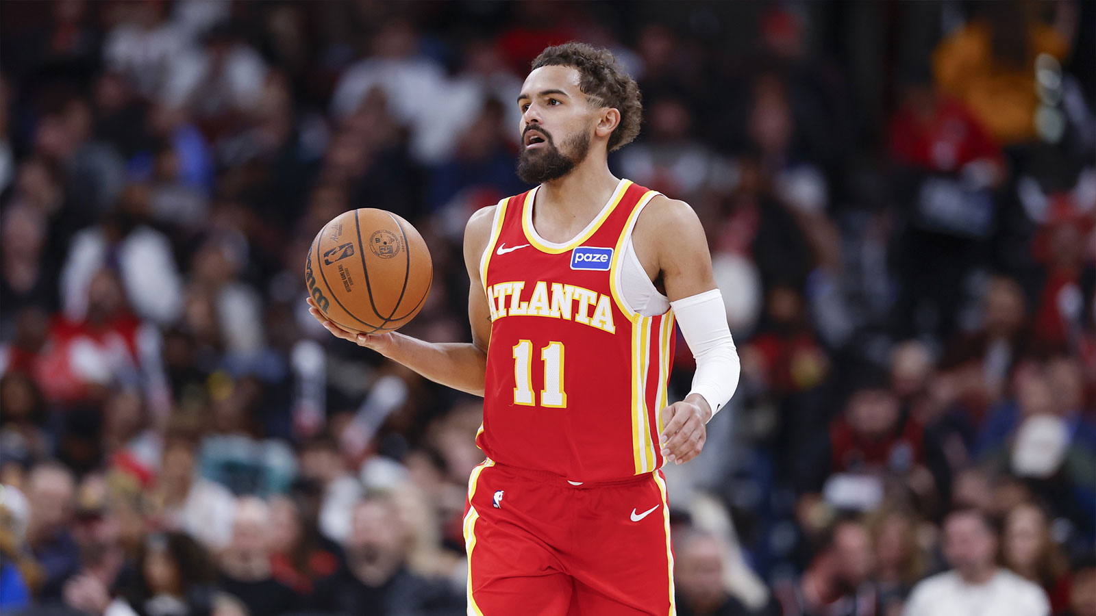 Hawks guard Trae Young (11) brings the ball up court against the Chicago Bulls during the second half at United Center