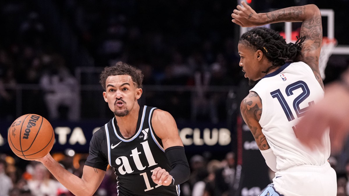 Hawks guard Trae Young (11) passes against Memphis Grizzlies guard Ja Morant (12) during the first half at State Farm Arena