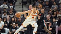 Hawks player Kristaps Porzingis (8) posts up