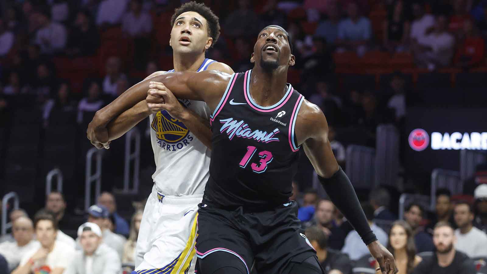 Heat center Bam Adebayo (13) and Golden State Warriors forward Trayce Jackson-Davis (32) wait for a rebound during the first half at Kaseya Center