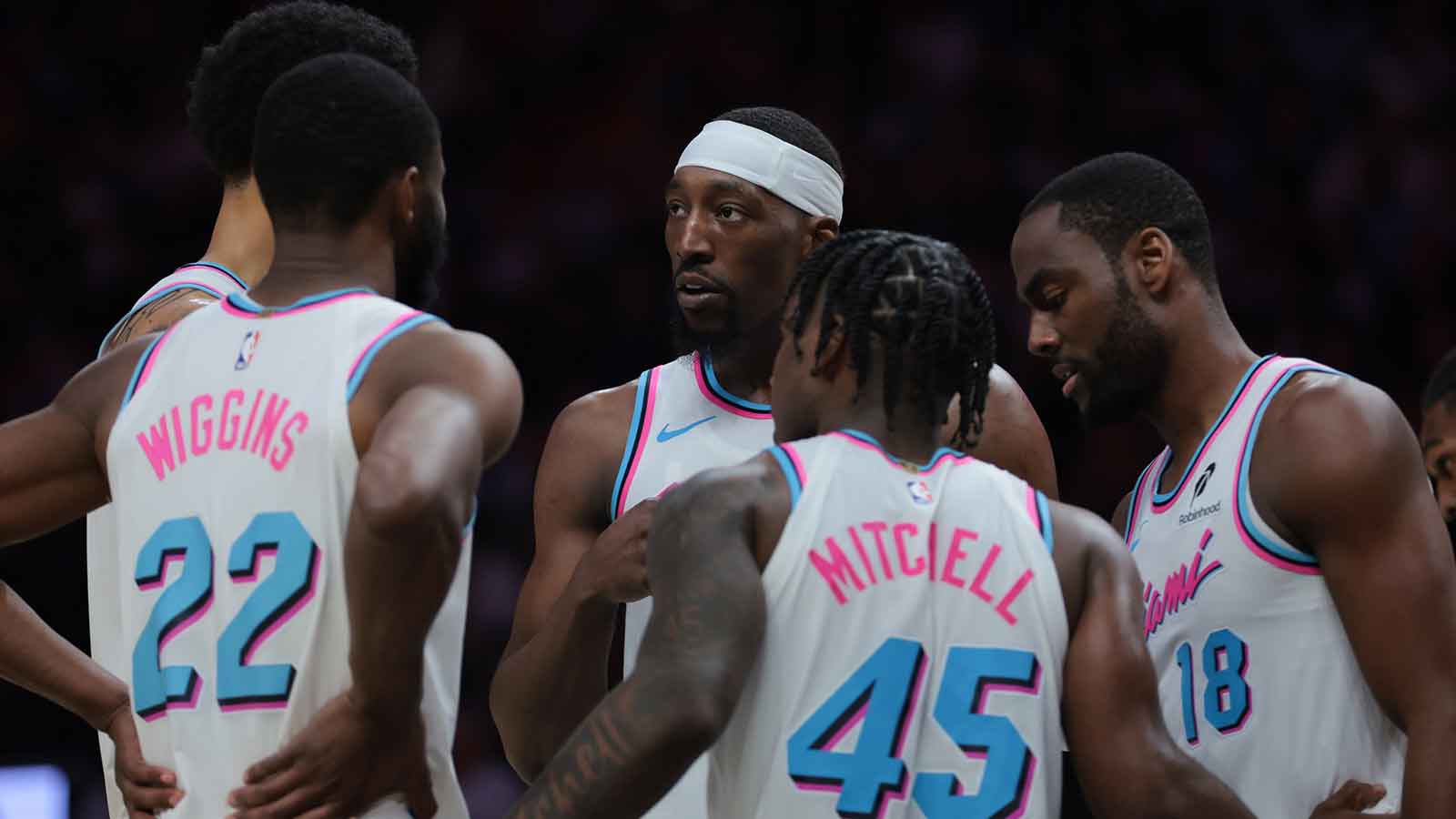 Heat center Bam Adebayo (13) talks to center Kel'el Ware (7), forward Andrew Wiggins (22), guard Davion Mitchell (45), and guard Alec Burks (18) during the second quarter against the Golden State Warriors at Kaseya Center