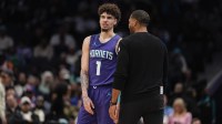 Hornets guard LaMelo Ball (1) talks with head coach Charles Lee during a free throw during the second half against the New York Knicks at Spectrum Center