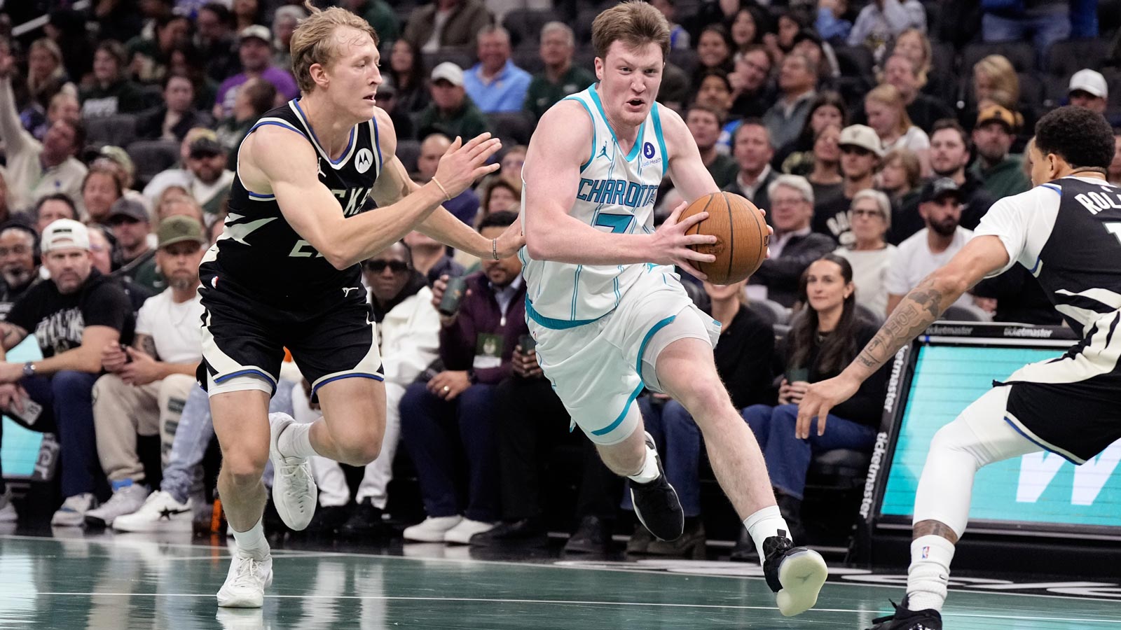 Hornets guard Kon Knueppel (7) drives towards the basket against Milwaukee Bucks guard AJ Green (20) during the first quarter at Fiserv Forum