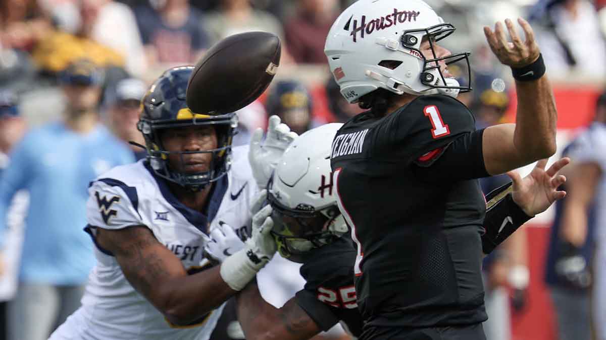 Houston Cougars quarterback Conner Weigman (1) fumbles the ball against the West Virginia Mountaineers in the first half at TDECU Stadium.