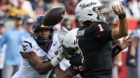 Houston Cougars quarterback Conner Weigman (1) fumbles the ball against the West Virginia Mountaineers in the first half at TDECU Stadium.