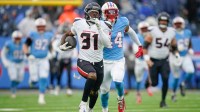 Houston Texans running back Dameon Pierce (31) runs in a touchdown past Tennessee Titans safety Mike Brown (44) during the second quarter at Nissan Stadium in Nashville, Tenn., Sunday, Jan. 5, 2025.