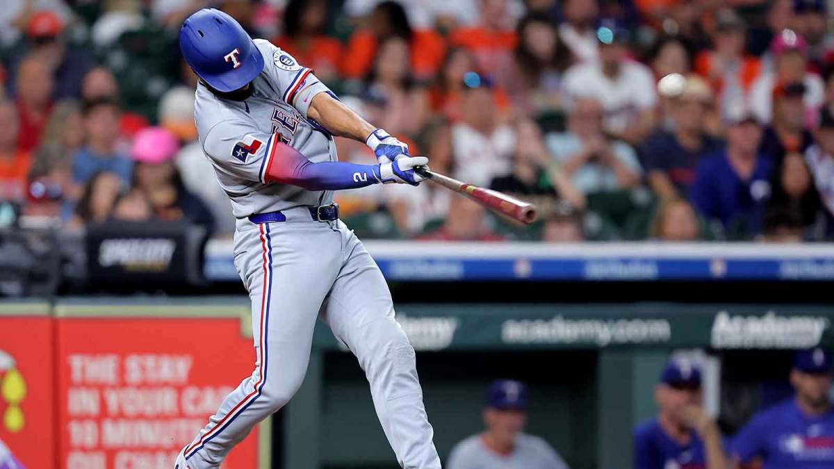 Texas Rangers second baseman Marcus Semien (2) hits a home run to left field against the Houston Astros during the eighth inning at Daikin Park.