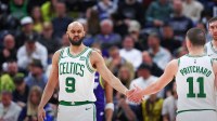 Boston Celtics guard Derrick White (9) slaps hands with Boston Celtics guard Payton Pritchard (11) after being fouled by the Utah Jazz during the fourth quarter at Delta Center.
