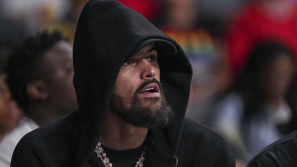 Atlanta Hawks player Trae Young watches the game between the Atlanta Dream against the Minnesota Lynx during the first half at Gateway Center Arena at College Park.