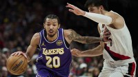 Los Angeles Lakers guard Nick Smith Jr. (20) drives to the basket during the second half against Portland Trail Blazers forward Deni Avdija (8) at Moda Center.