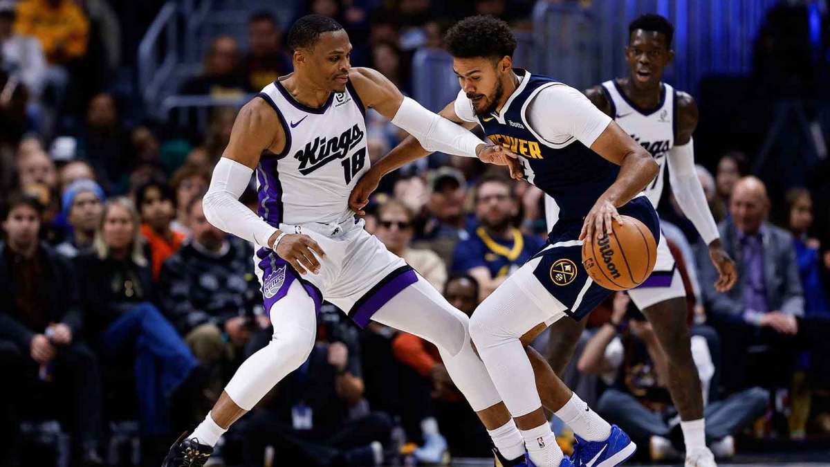 Denver Nuggets forward Cam Johnson (23) controls the ball as Sacramento Kings guard Russell Westbrook (18) guards in the fourth quarter at Ball Arena.
