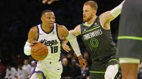 Sacramento Kings guard Russell Westbrook (18) works around Minnesota Timberwolves guard Donte DiVincenzo (0) in the third quarter at Target Center.