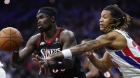 Philadelphia 76ers center Adem Bona (30) passes the ball past Detroit Pistons forward Bobi Klintman (34) during the second quarter at Xfinity Mobile Arena.