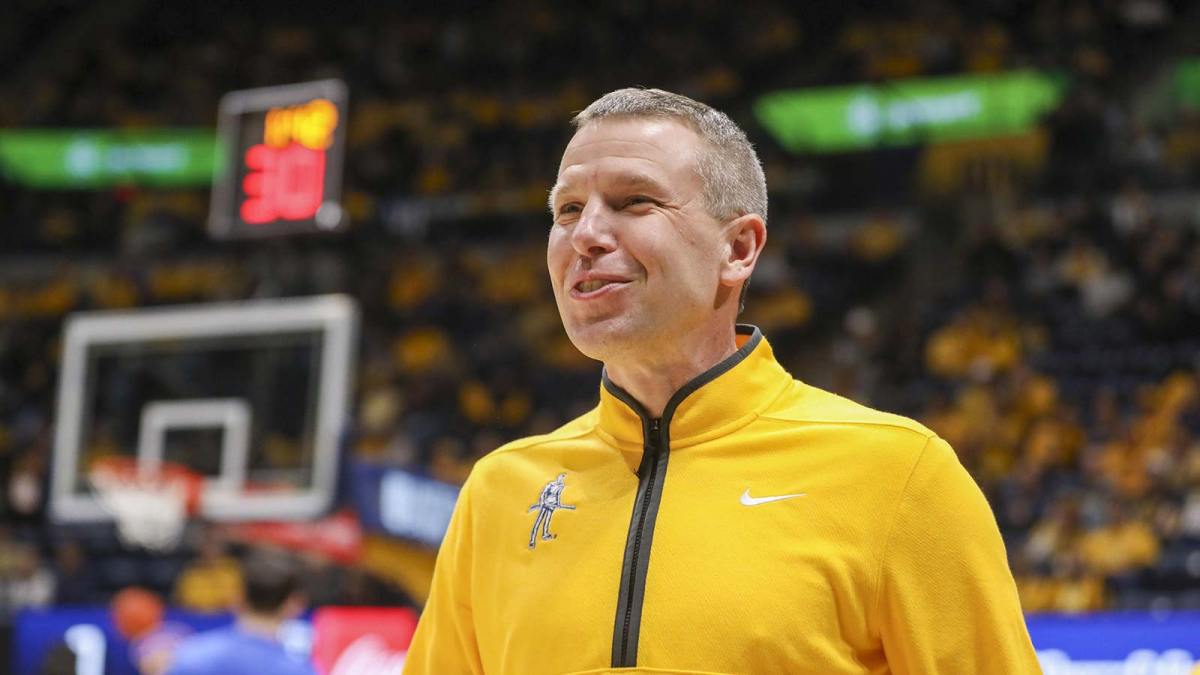 West Virginia Mountaineers head coach Ross Hodge smiles during pregame introductions before their game against the Pittsburgh Panthers at WVU Coliseum.