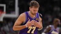 Los Angeles Lakers guard Luka Doncic (77) reacts after scoring a basket during the first quarter against the Milwaukee Bucks at Fiserv Forum.