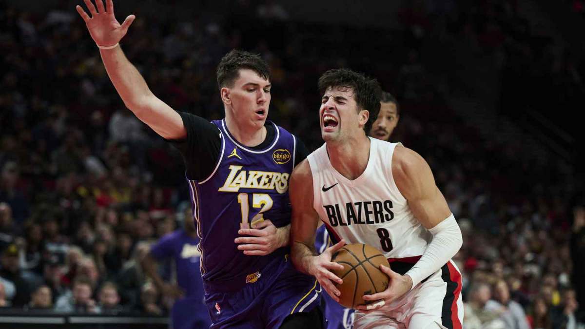 Portland Trail Blazers forward Deni Avdija (8) drives to the basket during the first half against Los Angeles Lakers forward Jake LaRavia (12) at Moda Center.