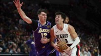 Portland Trail Blazers forward Deni Avdija (8) drives to the basket during the first half against Los Angeles Lakers forward Jake LaRavia (12) at Moda Center.
