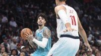 Charlotte Hornets guard LaMelo Ball (1) looks to pass as he is defended by Los Angeles Clippers center Brook Lopez (11) during the first half at the Spectrum Center.