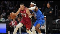 Miami Heat guard Tyler Herro (14) drives to the basket as Dallas Mavericks guard Brandon Williams (10) defends during the first half at Kaseya Center.