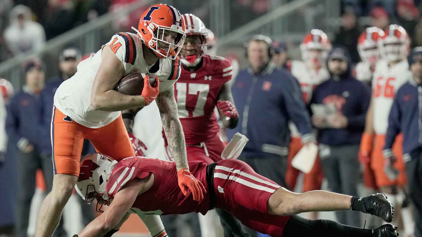 Illinois tight end Cole Rusk (14) is tackled by Wisconsin linebacker Mason Posa (8) during the second quarter of their game Saturday, November 22, 2025 at Camp Randall Stadium in Madison, Wisconsin.