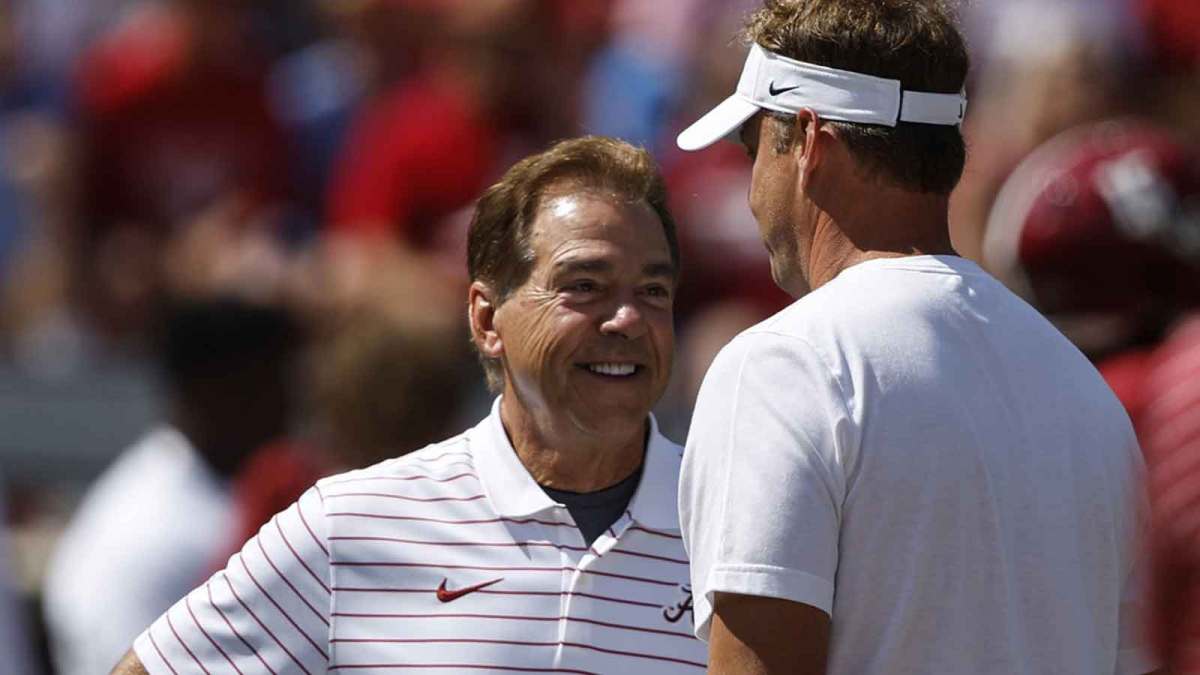 Alabama Crimson Tide head coach Nick Saban, left, talks with Mississippi Rebels head coach Lane Kiffin, right, before the game at Bryant-Denny Stadium.