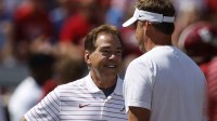 Alabama Crimson Tide head coach Nick Saban, left, talks with Mississippi Rebels head coach Lane Kiffin, right, before the game at Bryant-Denny Stadium.