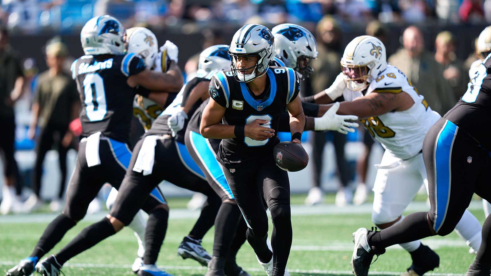 Carolina Panthers quarterback Bryce Young (9) hands the ball off during the first quarter against the New Orleans Saints at Bank of America Stadium.