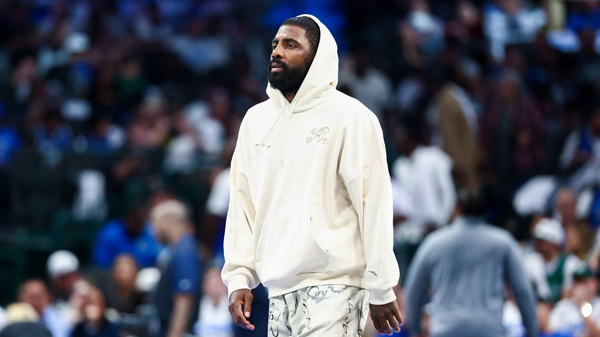 Dallas Mavericks injured guard Kyrie Irving walks across the court during the game against the San Antonio Spurs at American Airlines Center.