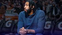Mavericks Anthony Davis looking serious and sitting on bench.
