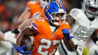 Denver Broncos running back J.K. Dobbins (27) rushes the ball against the Las Vegas Raiders during the first half at Empower Field at Mile High.