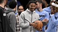 Memphis Grizzlies guard Ja Morant (12) looks on from the team bench during the second half against the Dallas Mavericks at the American Airlines Center. Mandatory Credit: Jerome Miron-Imagn Images