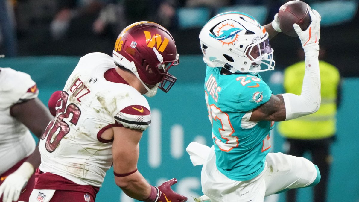 Miami Dolphins cornerback Jack Jones (23) interception a pass intended for Washington Commanders tight end Zach Ertz (86) in overtime during the 2025 NFL Madrid Game at Santiago Bernabeu Stadium.