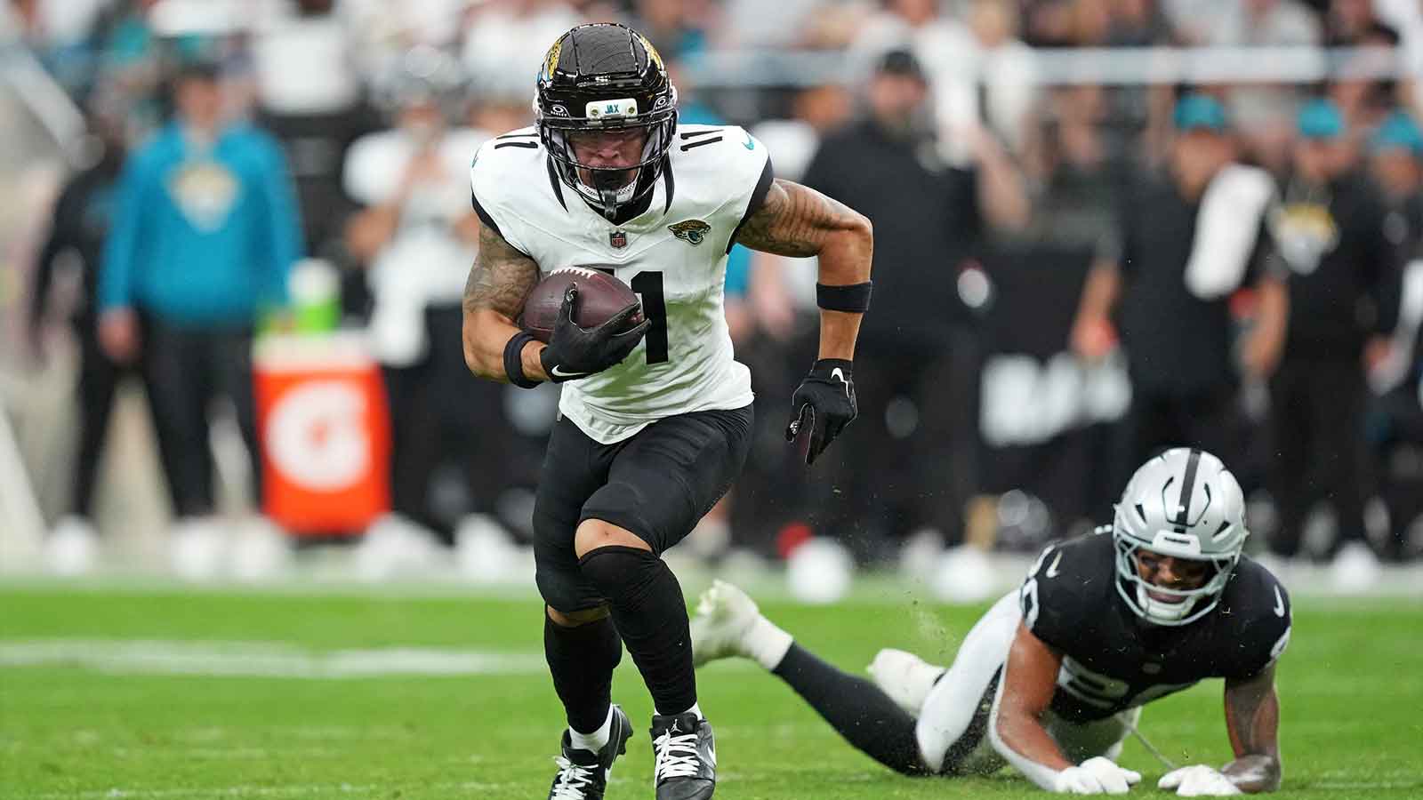Jacksonville Jaguars wide receiver Parker Washington (11) runs the ball during the first half against the Las Vegas Raiders at Allegiant Stadium