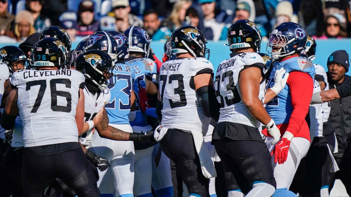 There’s a scuffle on the sidelines after a late hit on Jacksonville Jaguars quarterback Trevor Lawrence (16) by Tennessee Titans linebacker Arden Key (49) during the second quarter at Nissan Stadium.