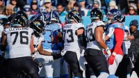 There’s a scuffle on the sidelines after a late hit on Jacksonville Jaguars quarterback Trevor Lawrence (16) by Tennessee Titans linebacker Arden Key (49) during the second quarter at Nissan Stadium.