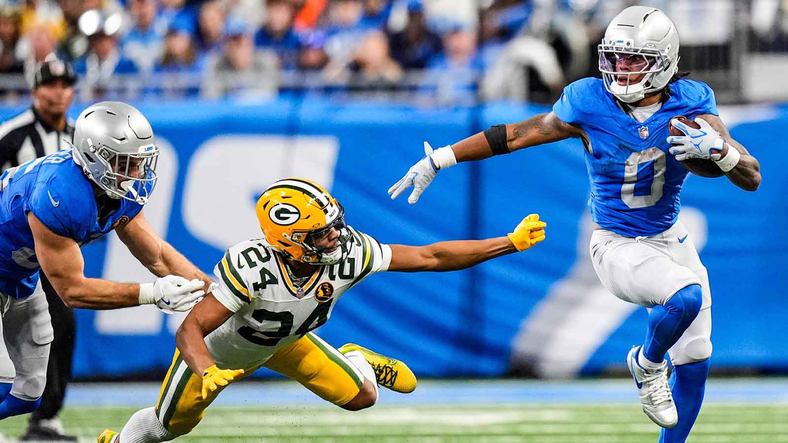 Detroit Lions running back Jahmyr Gibbs (0) runs against Green Bay Packers cornerback Carrington Valentine (24) during the second half at Ford Field in Detroit on Thursday, Nov. 27, 2025.