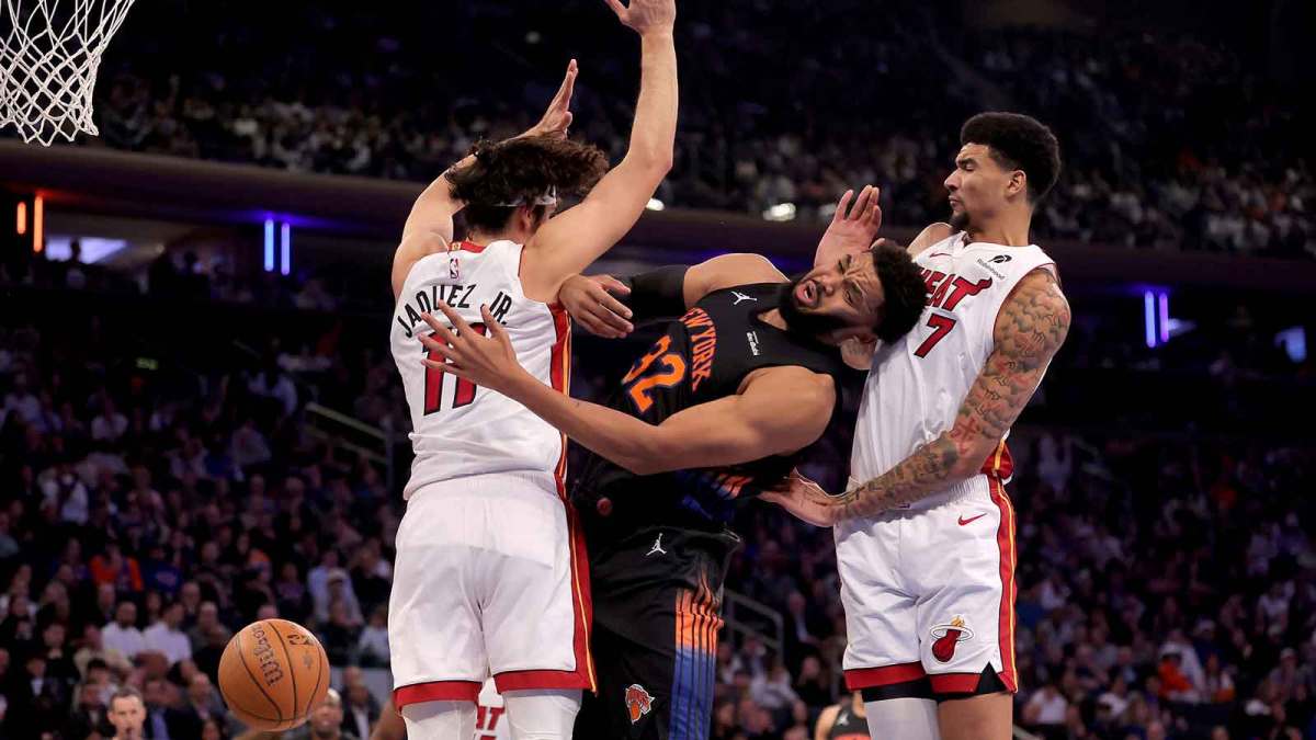 New York Knicks center Karl-Anthony Towns (32) loses the ball as he drives to the basket against Miami Heat forward Jaime Jaquez Jr. (11) and center Kel'el Ware (7) during the first quarter at Madison Square Garden.