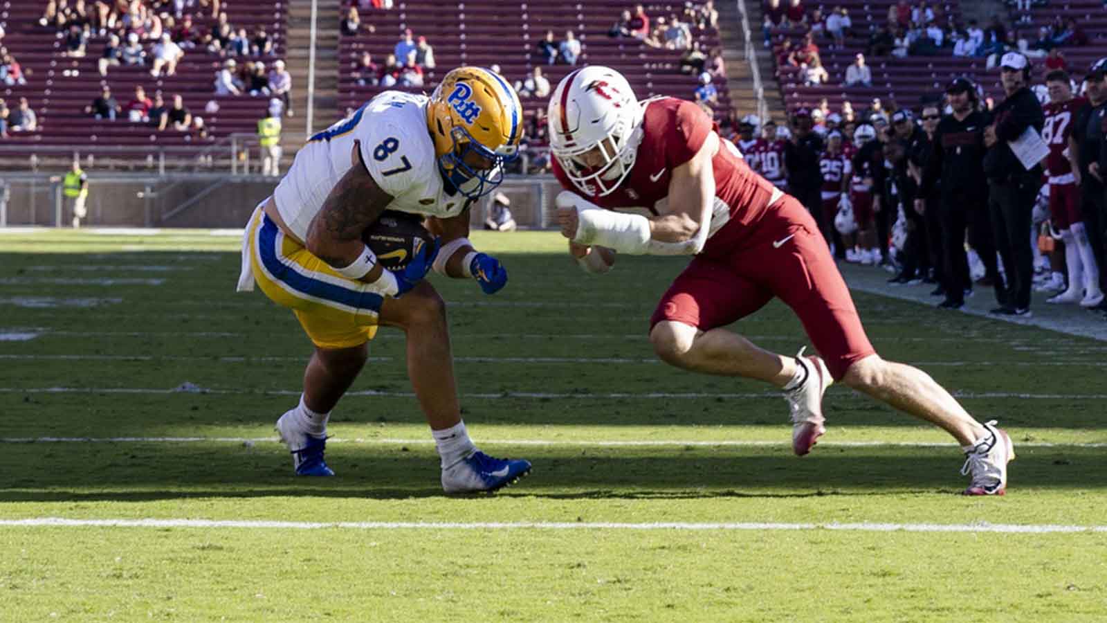 Pittsburgh Panthers tight end Jake Overman (87) scores a touchdown as Stanford Cardinal safety Charlie Eckhardt (39) defends during the third quarter at Stanford Stadium.