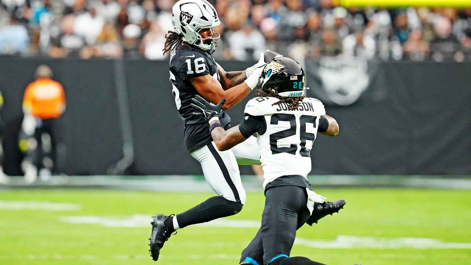 Jacksonville Jaguars safety Antonio Johnson (26) tackles Las Vegas Raiders wide receiver Jakobi Meyers (16) during the second half at Allegiant Stadium. 