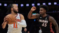 New York Knicks guard Jalen Brunson (11) protects the basketball from Miami Heat guard Davion Mitchell (45) during the second quarter at Kaseya Center.