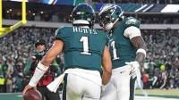 Philadelphia Eagles wide receiver A.J. Brown (11) and quarterback Jalen Hurts (1) celebrate a touchdown against the Washington Commanders in the NFC Championship game at Lincoln Financial Field.