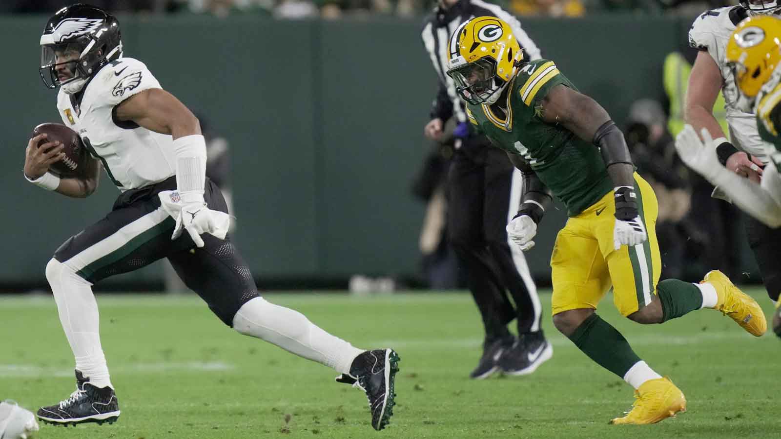 Philadelphia Eagles quarterback Jalen Hurts (1) is pursued by Green Bay Packers defensive end Micah Parsons (1) the second quarter of their game Monday, November 10, 2025 at Lambeau Field in Green Bay, Wisconsin.