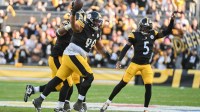 Pittsburgh Steelers defensive tackle Derrick Harmon (99) celebrates with Jalen Ramsey (5) after recovering a fumble by Indianapolis Colts quarterback Daniel Jones (17) during the second half at Acrisure Stadium.