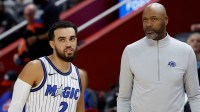 Orlando Magic head coach Jamahl Mosley talks to guard Tyus Jones (2) in the first half against the Detroit Pistons at Little Caesars Arena.