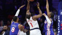 LA Clippers guard James Harden (1) drives for a shot against Philadelphia 76ers forward Paul George (8) and guard Tyrese Maxey (0) during the first quarter at Xfinity Mobile Arena.