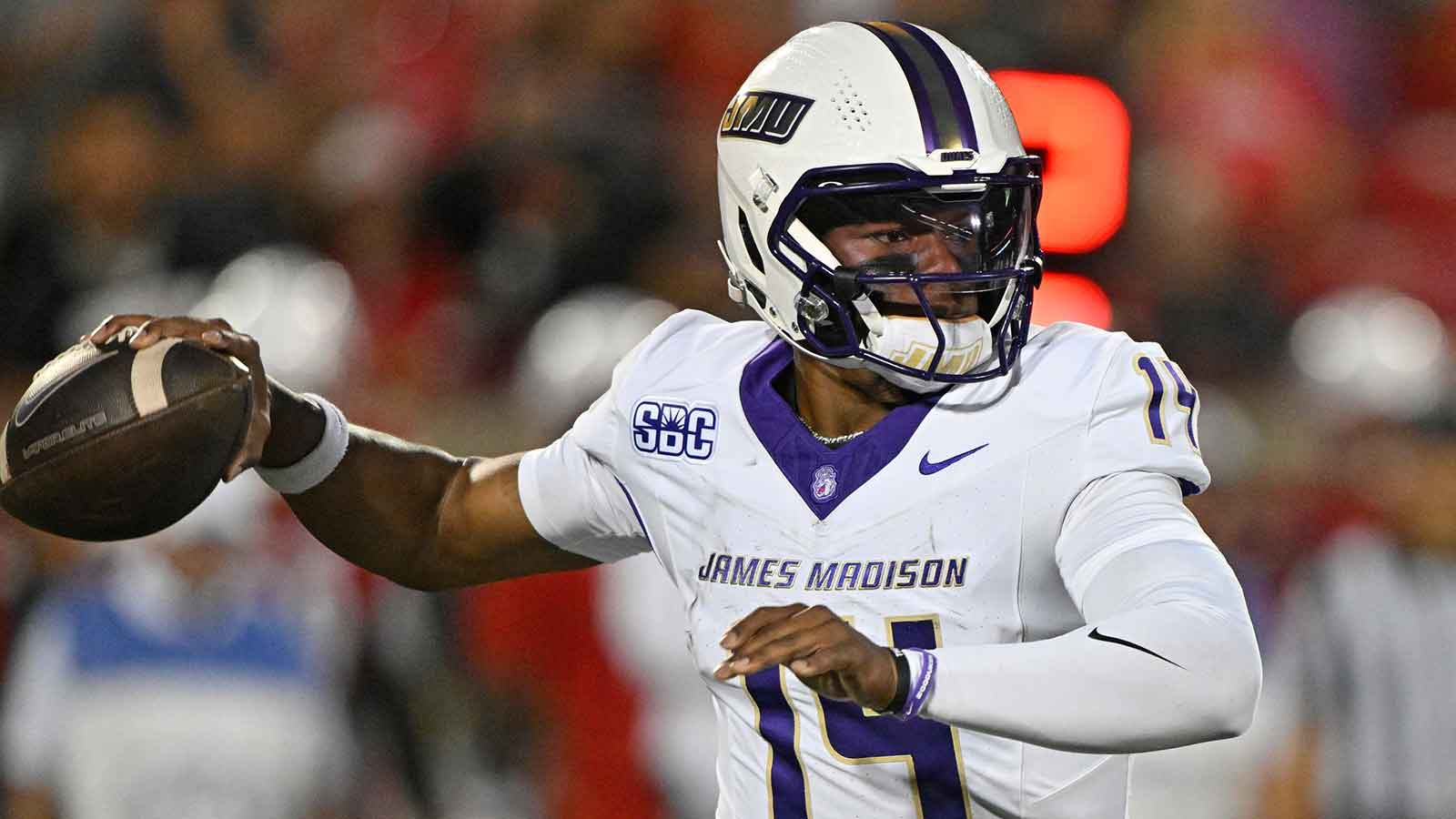 James Madison Dukes quarterback Alonza Barnett III (14) looks to pass against the Louisville Cardinals during the first half at L&N Federal Credit Union Stadium. Louisville defeated James Madison 28-14