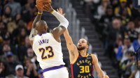 Golden State Warriors guard Stephen Curry (30) defends against Los Angeles Lakers forward LeBron James (23) during the fourth quarter at Chase Center