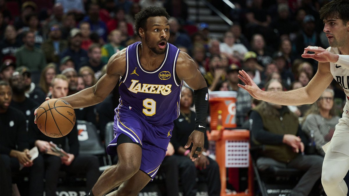 Los Angeles Lakers guard Bronny James (9) drives to the basket during the second half against Portland Trail Blazers forward Deni Avdija (8) at Moda Center.