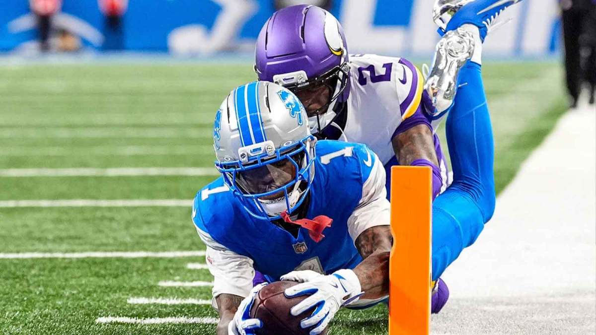 Detroit Lions wide receiver Jameson Williams (1) dives for a touchdown against Minnesota Vikings cornerback Isaiah Rodgers (2) during the second half at Ford Field in Detroit on Sunday, November 2, 2025.