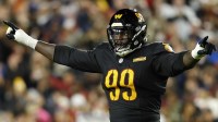 Washington Commanders defensive tackle Javon Kinlaw (99) reacts after a play against the Chicago Bears during the second quarter at Northwest Stadium.